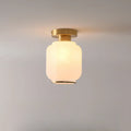 Plafonnier semi-encastré moderne en verre blanc et doré, style tambour.